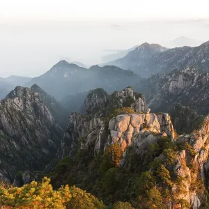 Morning atmosphere, fog, bizarre towering rocks and mountains covered with scattered trees