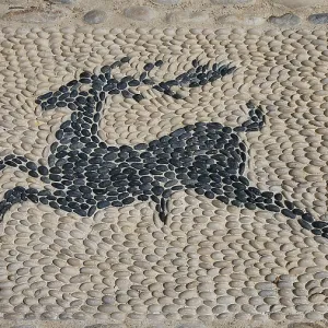 Mosaic artwork of a deer made of pebbles in the street