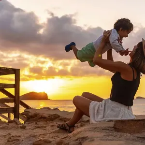 Mother having fun with her son at sunset in Cala Comte beach on the island of Ibiza Mother having fun with her son at sunset in Cala Comte beach on the island of Ibiza