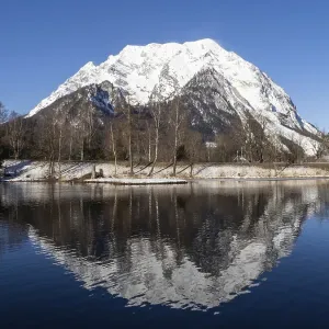 Mount Grimming reflected in the lake in winter Mount Grimming reflected in the lake in winter