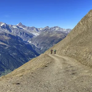 Mountain biker on the Breithorn with panorama over the Upper Valais to the Aletsch area with Eggishorn Mountain biker on the Breithorn with panorama over the Upper Valais to the Aletsch area with Eggishorn