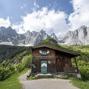 Mountain hut Ackerlhutte, rocky mountain peaks behind