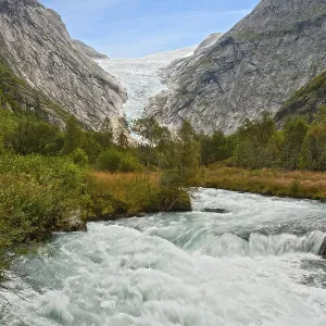 Mountain landscape with a glacier and rough river