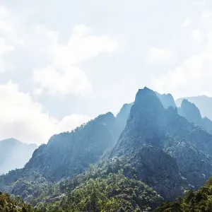 Mountain landscape, silhouettes of mountain ridges with clouds