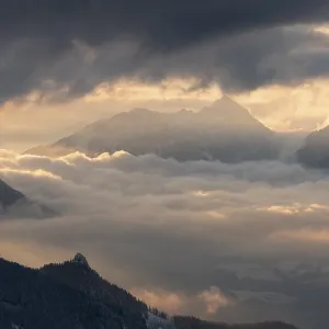 Mountain landscape during sunset with mystical clouds
