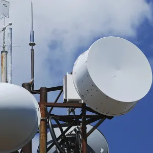 Mountain peak antennas and communication equipment closeup on blue-sky background
