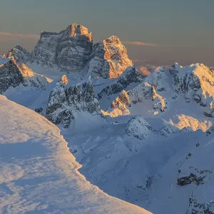 Mountain peak in the snow at sunset