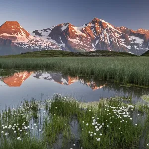 Mountain peaks are reflected in a small pond