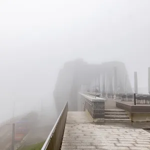 Mountain Train on Railroad Tracks and Restaurant Terrace in the Clouds in a Cloudy Day in Monte Generoso
