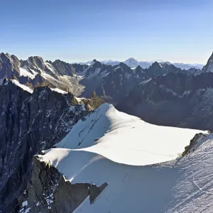 Mountaineers climb over a snow-covered ridge