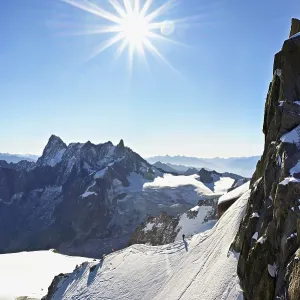 Mountaineers climb over a snow-covered ridge
