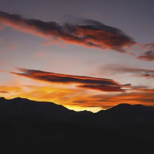 Mountains in the clouds at sunset in summer