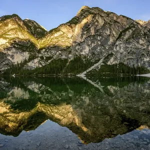 Mountains in the evening light are reflected in Lake Prags Lake Mountains in the evening light are reflected in Lake Prags Lake
