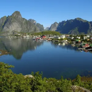 Mountains and houses reflect in the fjord Reine Moskenesoya Lofoten Norway Mountains and houses reflect in the fjord Reine Moskenesoya Lofoten Norway