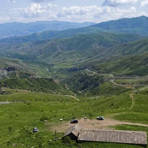 Mountains with isolated vehicles in a meadow Mountains with isolated vehicles in a meadow