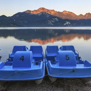 Mountains reflected in lake, pedal boats Mountains reflected in lake, pedal boats