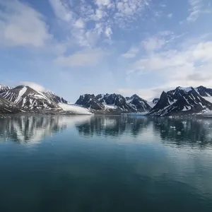 Mountains reflecting in the water in the Magdalenefjorden