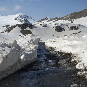 Mountains with snow and ice on road