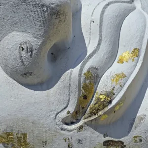 Mouth of a lying Buddha statue decorated with gold leaf