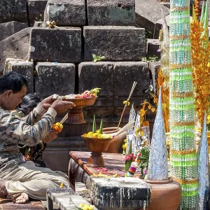 Muang Champassak, Laos - Feb 2016: Couple praying at old temple of Wat Phou