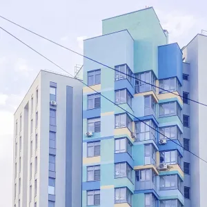 Multi-story residential building in blue and yellow colors