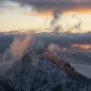 Mysterious mountains in fog at sunset