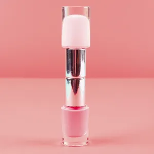 Two nail polish bottles against coral diagonal backdrop Two nail polish bottles against coral diagonal backdrop