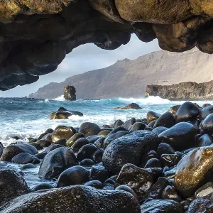 Natural arch of stones next to the La Maceta rock pool on the island of El Hierro in the Canary Islands Natural arch of stones next to the La Maceta rock pool on the island of El Hierro in the Canary Islands