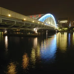 Nighttime colorful reflection of Eitai Bridge illumination in waters of Sumida river at central part of Tokyo