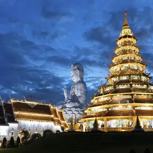 Nine-storey Chinese pagoda and chapel with huge Guan Yin statue at dusk