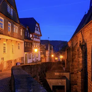 A nocturnal old town with half-timbered houses and cobblestones A nocturnal old town with half-timbered houses and cobblestones