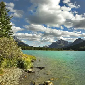 Northern lake surrounded by a wood and mountains in Canada Northern lake surrounded by a wood and mountains in Canada