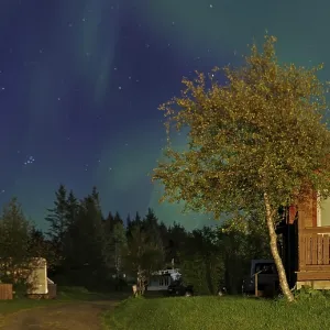 Northern lights (aurora borealis) over holiday homes Northern lights (aurora borealis) over holiday homes