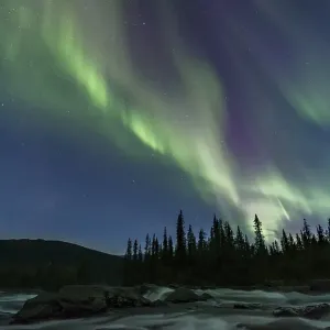 Northern Lights or Aurora Borealis above river Gamajahka or Kamajakka