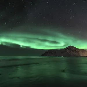 Northern Lights (Aurora Borealis) with starry sky at the beach Northern Lights (Aurora Borealis) with starry sky at the beach