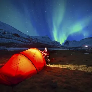 Northern Lights (Aurora borealis) over a tent in winter