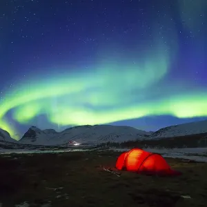 Northern Lights (Aurora borealis) over a tent in winter Northern Lights (Aurora borealis) over a tent in winter