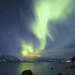 Northern Lights over fjord with winter landscape Northern Lights over fjord with winter landscape