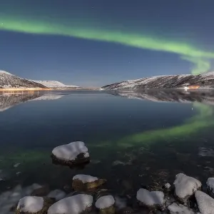 Northern lights reflected in fjord