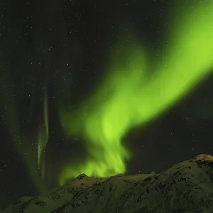 Northern Lights over snow covered mountains