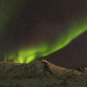 Northern Lights over snow covered mountains