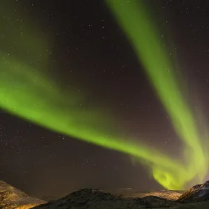 Northern Lights over snow covered mountains
