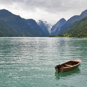 The Norwegian landscape with a boat on lake against mountains