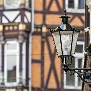 Nostalgic lantern in front of a half-timbered house with traditional architectural elements Nostalgic lantern in front of a half-timbered house with traditional architectural elements