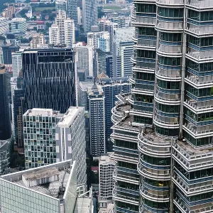 Nov 20, 2019 - Kuala Lumpur, Malaysia: Contemporary downtown cityscape with close up of iconic Petronas Towers facade