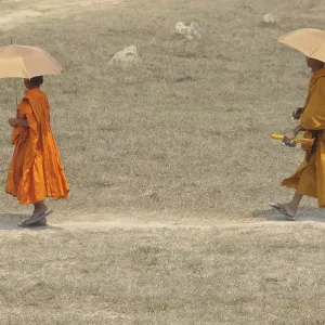 Novice and a monk with sunshades, Cambodia, Asia Novice and a monk with sunshades, Cambodia, Asia
