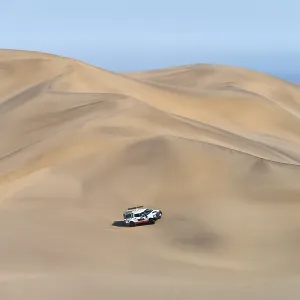 Off-road vehicle in sand dunes above the Orange River