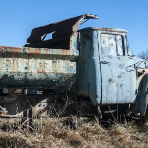 Old abandoned dirty broken vintage truck in the middle of paintball field playground Old abandoned dirty broken vintage truck in the middle of paintball field playground
