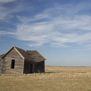 An old, abandoned farmhouse on the North Dakota prairie An old, abandoned farmhouse on the North Dakota prairie