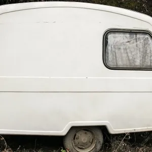 Old abandoned weathered small white vintage caravan Old abandoned weathered small white vintage caravan